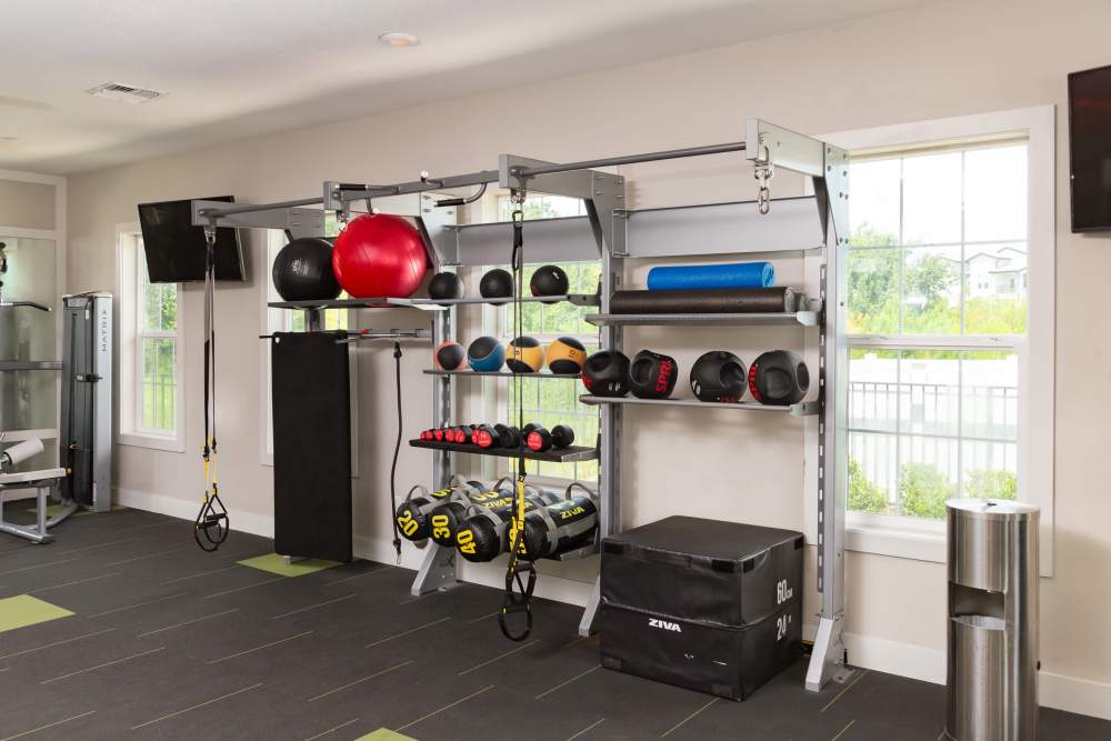 Fully-equipped gym with treadmills and flat-screen TVs at Shadetree Apartments in Ruskin, Florida