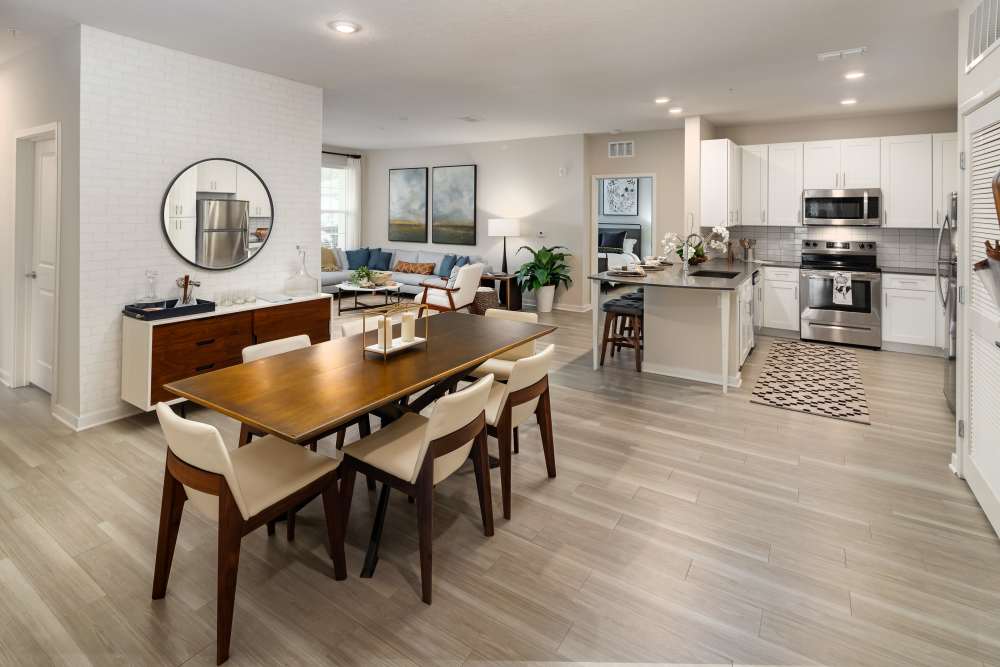 Thoughtfully designed living room with wood flooring and plenty of natural light at Shadetree Apartments in Ruskin, Florida