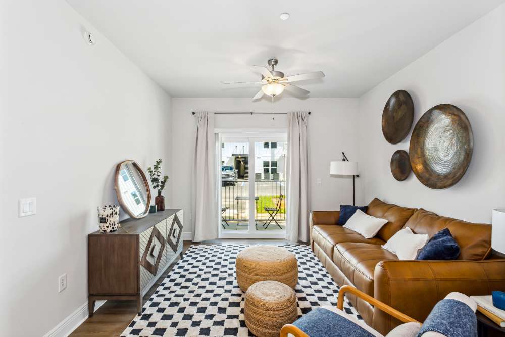Pet-Friendly Apartments in Pensacola, FL - City North- Living Room with Ceiling Fan, Wood-Style Floors, and Fireplace