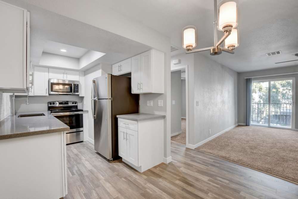 Apartment kitchen with wood-style flooring at Cascade Apartments in Henderson, Nevada