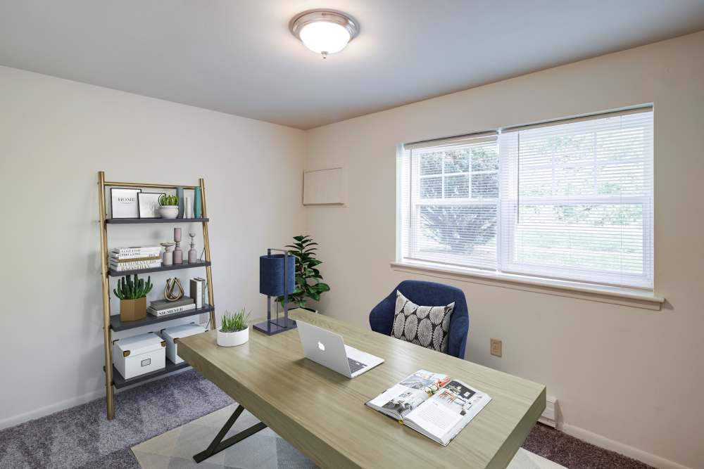 Bedroom staged as a home office with wall to wall carpeting at Presidential Arms Apartment Homes in Allison Park, Pennsylvania