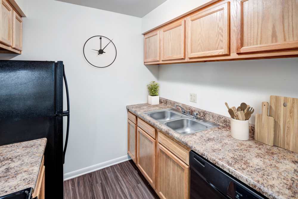 Kitchen with oak cabinets and black appliances at Presidential Arms Apartment Homes in Allison Park, Pennsylvania