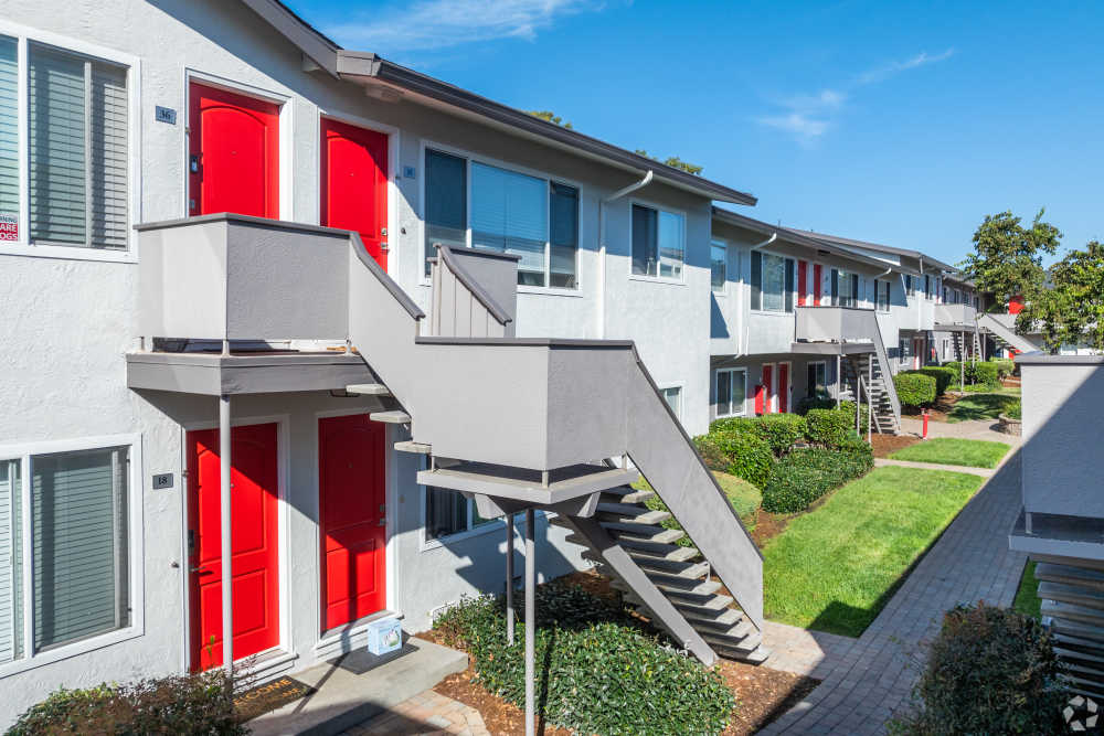 Two-Bedroom Apartments in San Leandro, CA - Marina Plaza Apartments - Courtyard with a Manicured Lawn, Apartment Complex View, and Sidewalk Access
