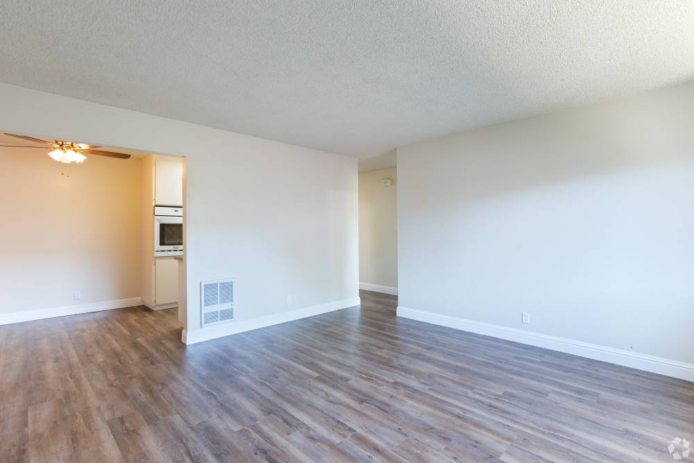 Pet-Friendly Apartments in San Leandro, CA - Marina Plaza Apartments- Living Room with Wood-Style Floors and tons of space