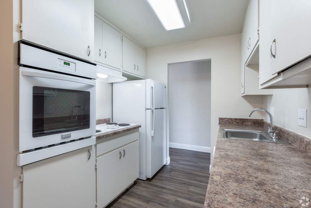 San Leandro, CA Pet-Friendly Apartments - Marina Plaza Apartments - Kitchen with Stainless-Steel Appliances, Cabinets, and Granite-Style Countertops