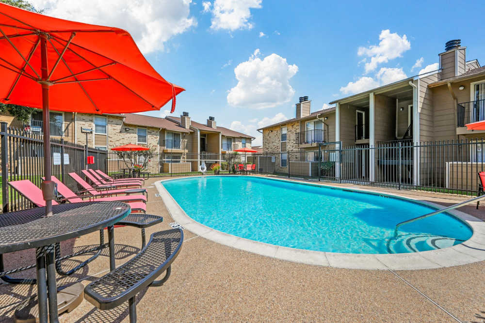 Swimming pool with side seating area at Broadmoor Place in Irving, Texas