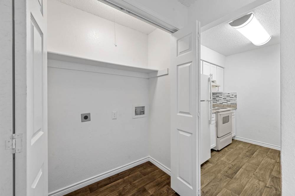 Closet and a view of kitchen with appliances at Broadmoor Place in Irving, Texas