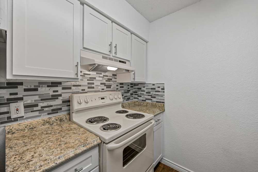 Kitchen with stove and appliances at Broadmoor Place in Irving, Texas