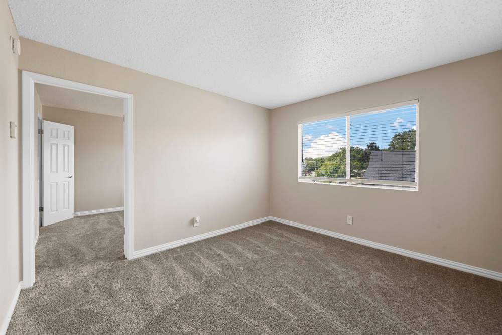 Bright living room with large window at Village Square in Irving. TX
