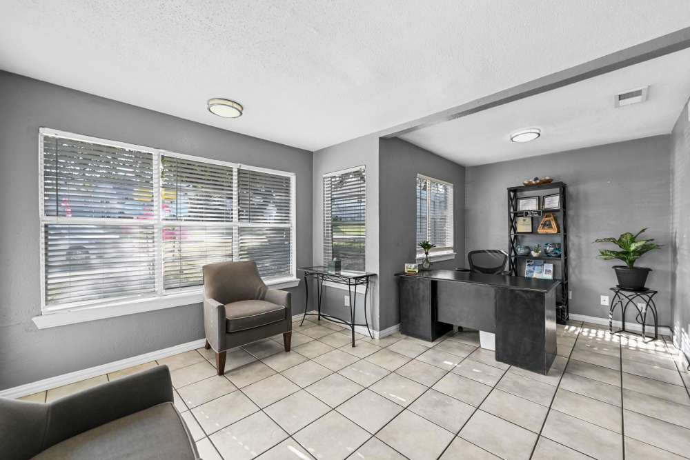Community waiting hall with chairs and a desk at Village Square in Irving. TX