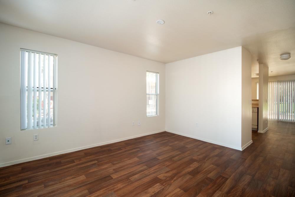 Wood-style flooring in an apartment living room at Steeple Chase Apartments in Peoria, Arizona
