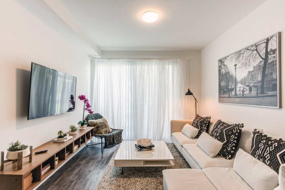 Living room with white sectional at Sophia Square in Homestead, Florida