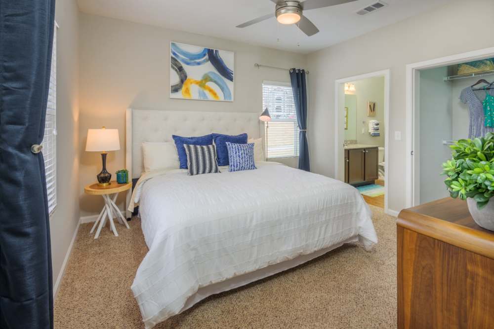 Brightly lit bedroom with carpet and ceiling fan at Retreat at RTP in Durham, North Carolina