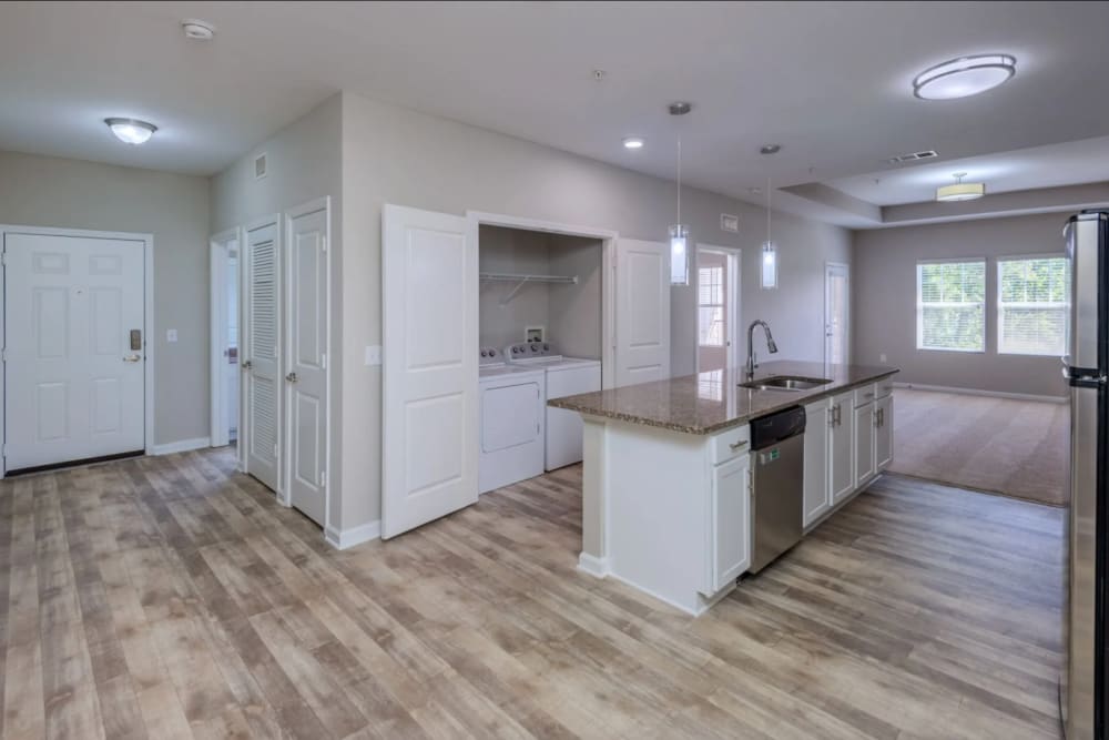 Kitchen with hardwood floors and washer/dryer at Retreat at RTP in Durham, North Carolina