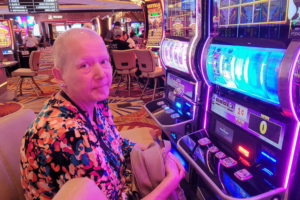Resident playing a slot machine at Lighthouse Pointe by Barclay House in Chesapeake, Virginia