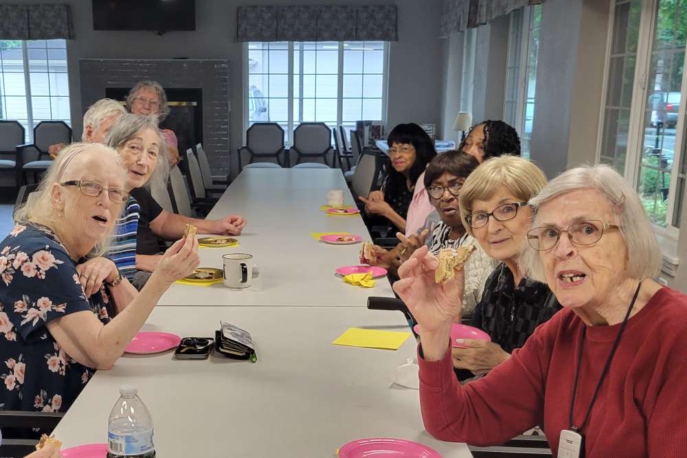 Residents socializing and enjoying snacks at Lighthouse Pointe by Barclay House in Chesapeake, Virginia
