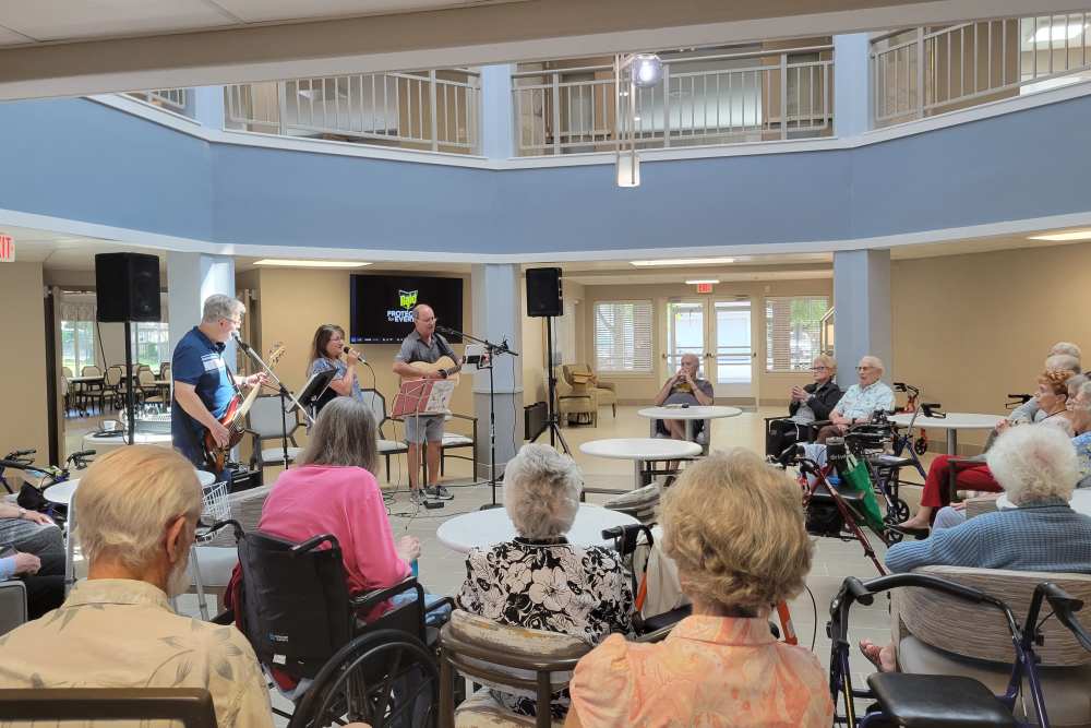 Residents listening to live music at Lighthouse Pointe by Barclay House in Chesapeake, Virginia