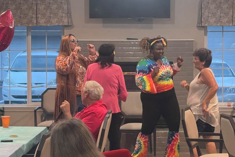 Staff with residents at a themed party at Lighthouse Pointe by Barclay House in Chesapeake, Virginia