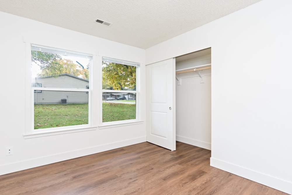 Bedroom with expansive window, LVP flooring and closet