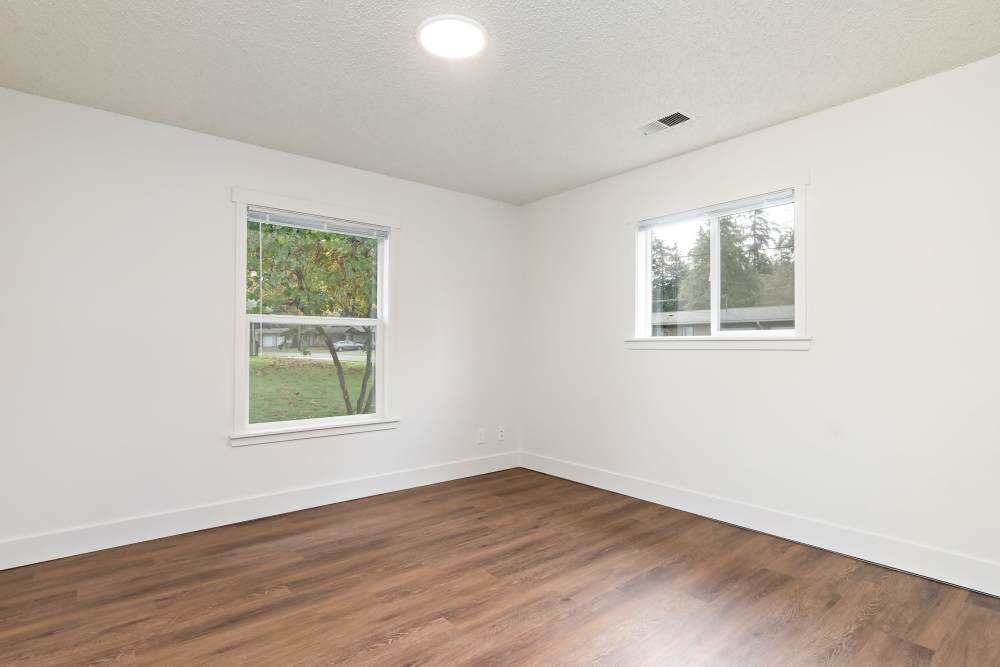 Bedroom with expansive window, LVP flooring and closet