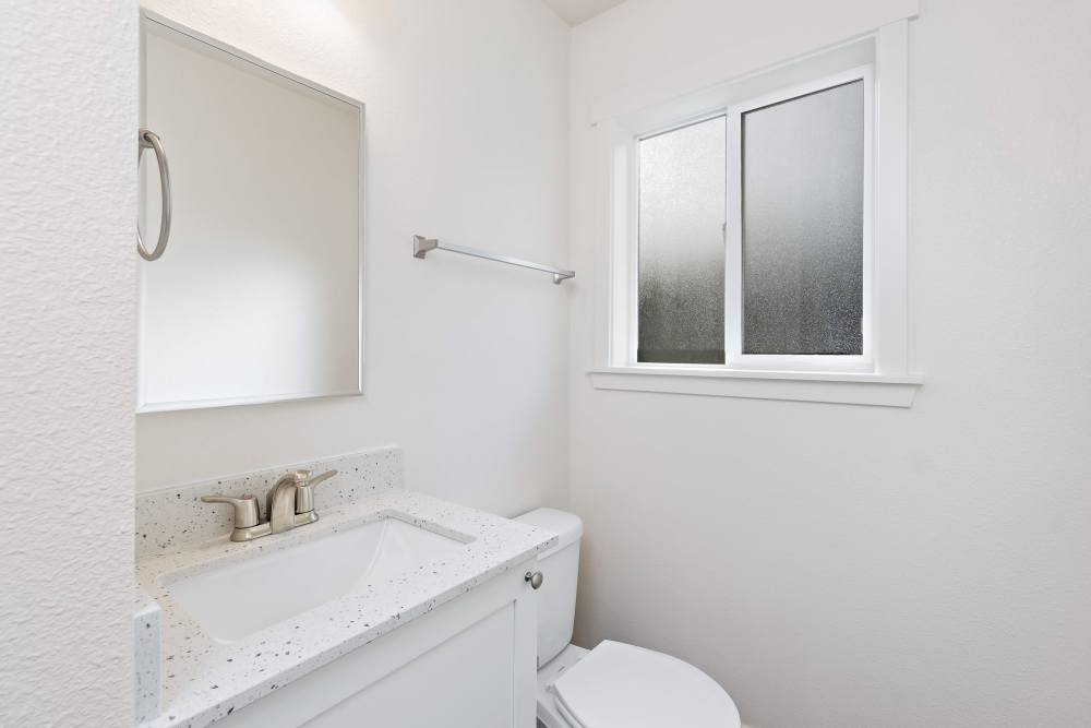 Bathroom with quartz countertop and window