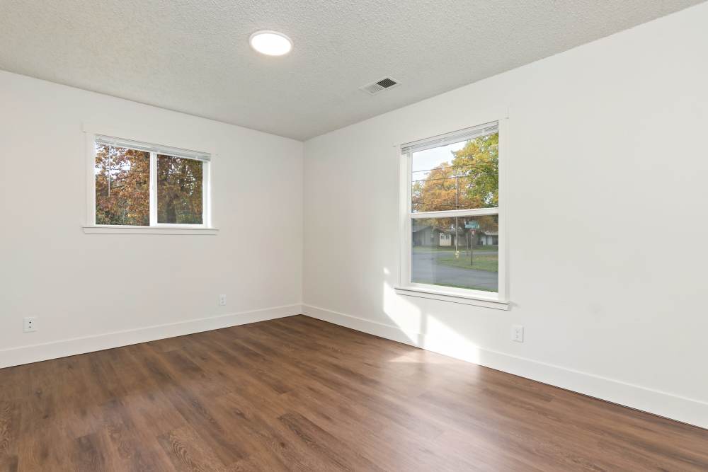 Bedroom with expansive window, LVP flooring and closet