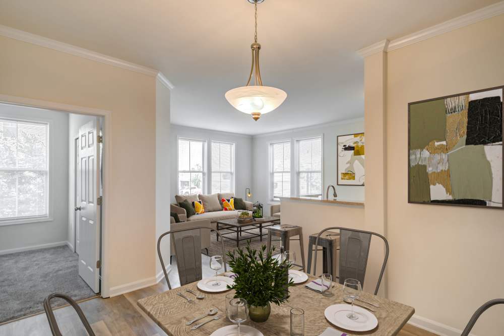The west dining area with views of the living room at Manassas Station Apartments in Manassas, Virginia