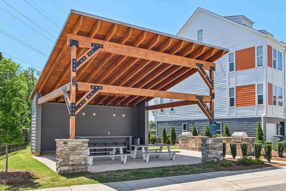 Exterior seating area with grilling station at Crossings At NoDa in Charlotte, North Carolina