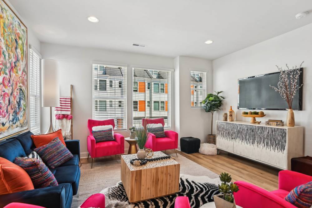 Living room with window and television at Crossings At NoDa in Charlotte, North Carolina