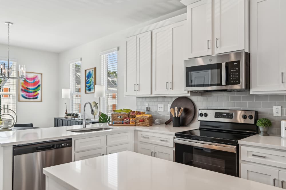 Kitchen with white countertop at Crossings At NoDa in Charlotte, North Carolina