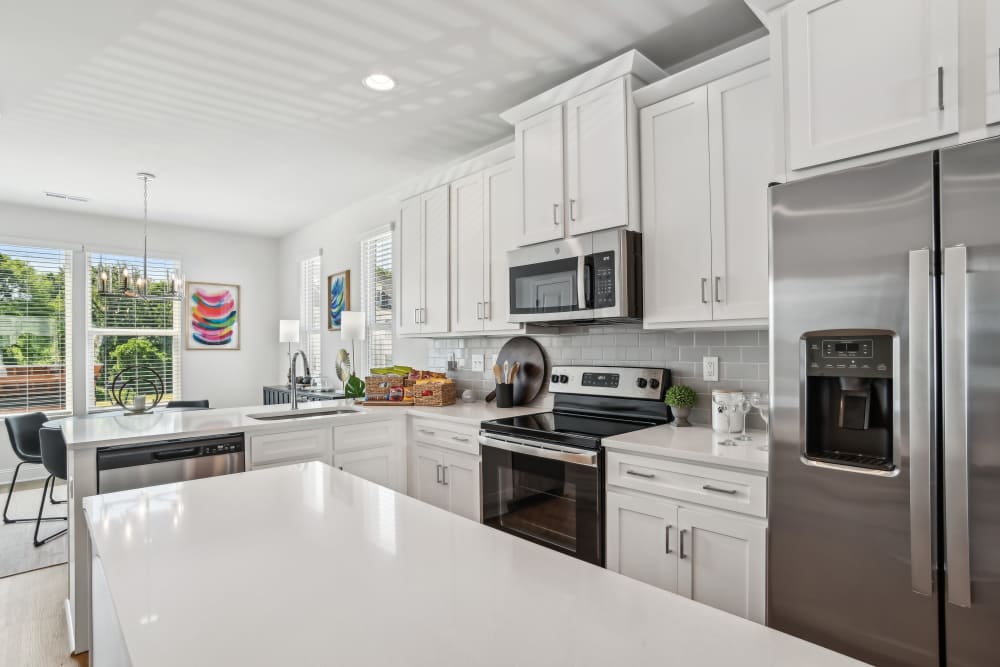 Kitchen with stainless steel appliance at Crossings At NoDa in Charlotte, North Carolina