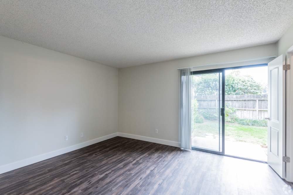 Living room with doors to private patio at Ashford Park in Sacramento, California