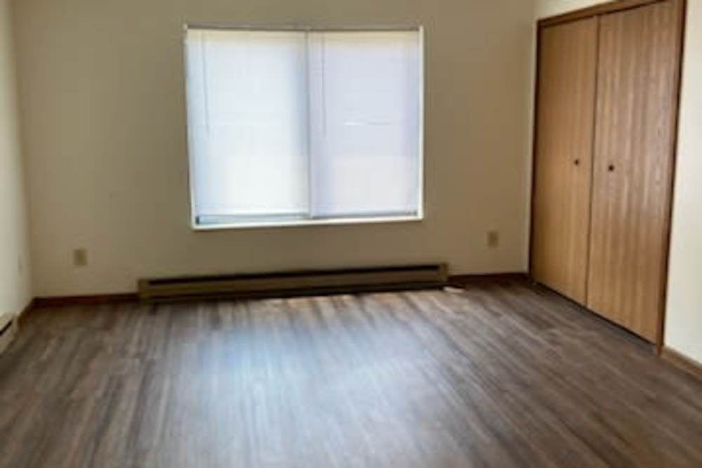 Living room with wood floor at West Elm Villas in Wauseon, Ohio