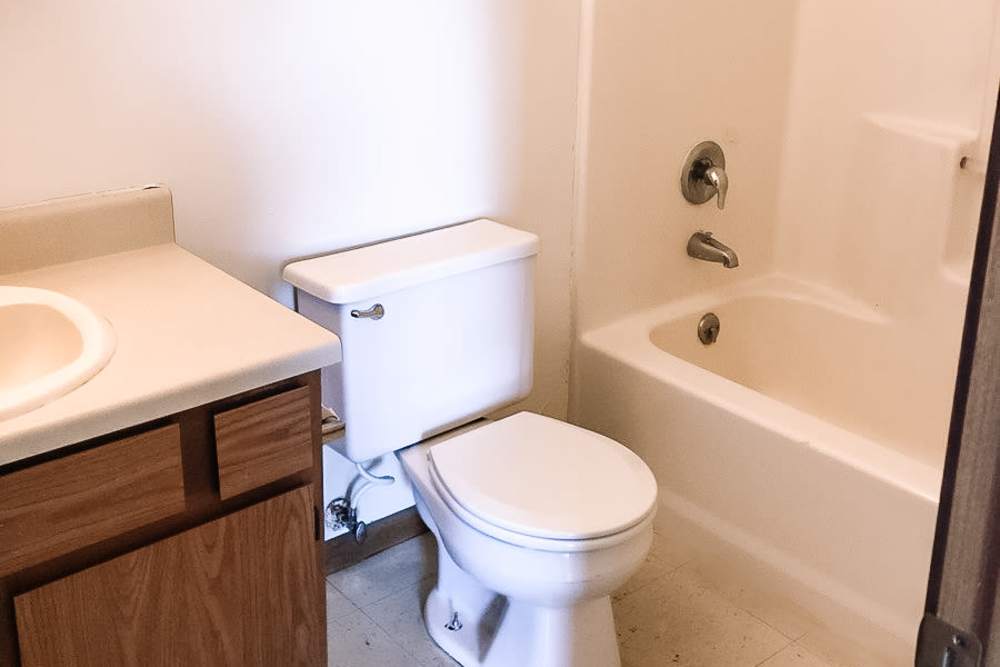 Bright bathroom with shower and tub at Riverside Villas in Columbia City, Indiana