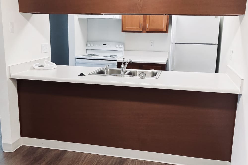 Comfortable apartment kitchen at Maple Heights Apartments in Saline, Michigan