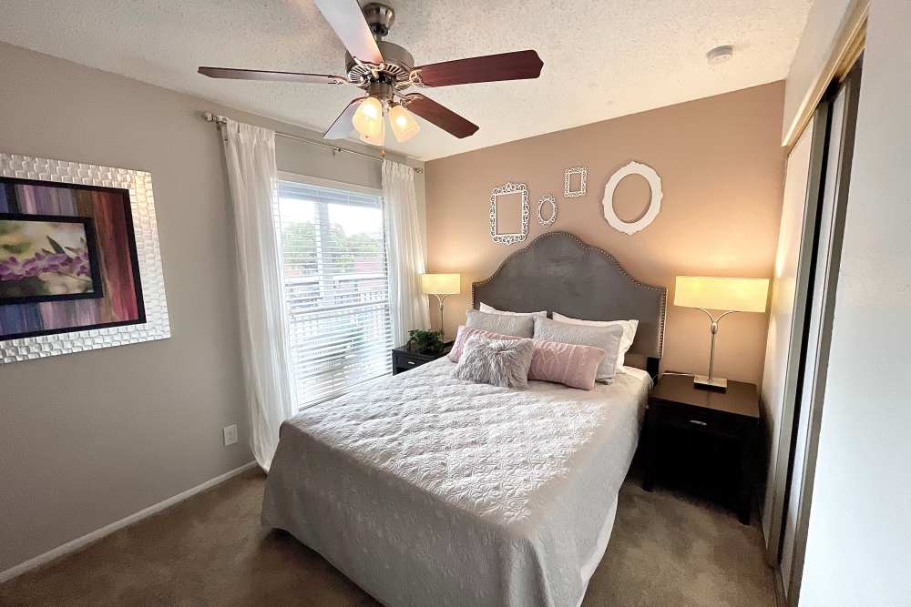 Bedroom with ceiling fan at The Abbey at Medical Center in San Antonio, Texas