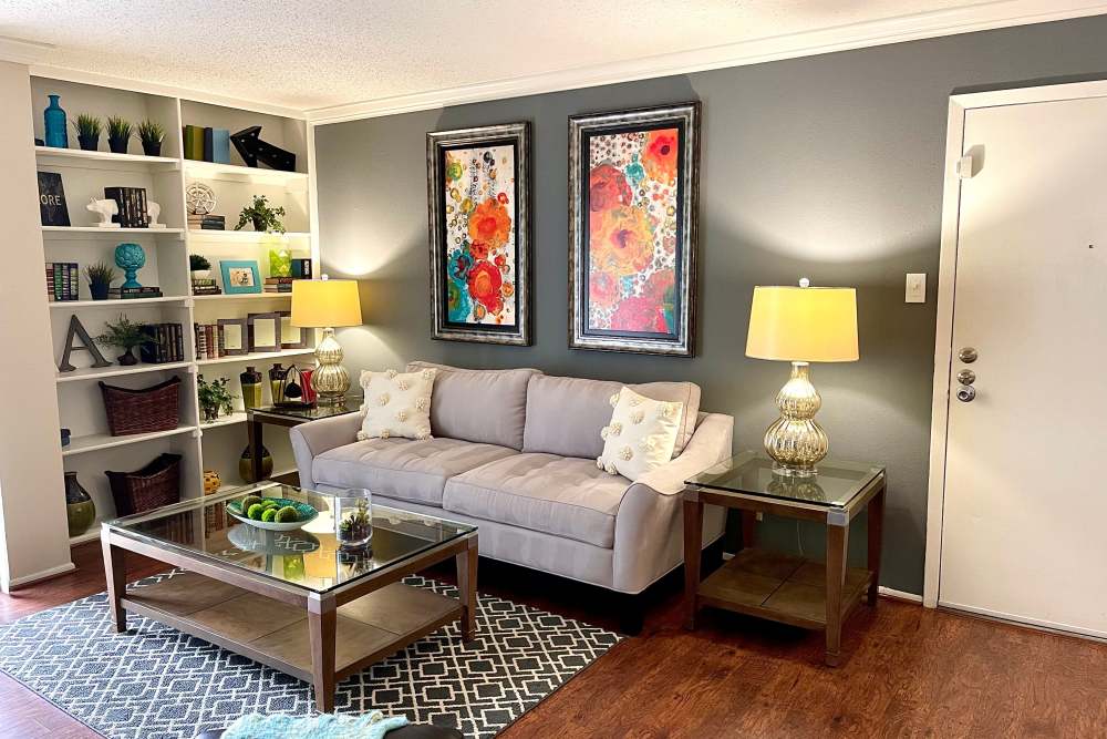 Living room with  built-in bookshelf at The Abbey at Medical Center in San Antonio, Texas