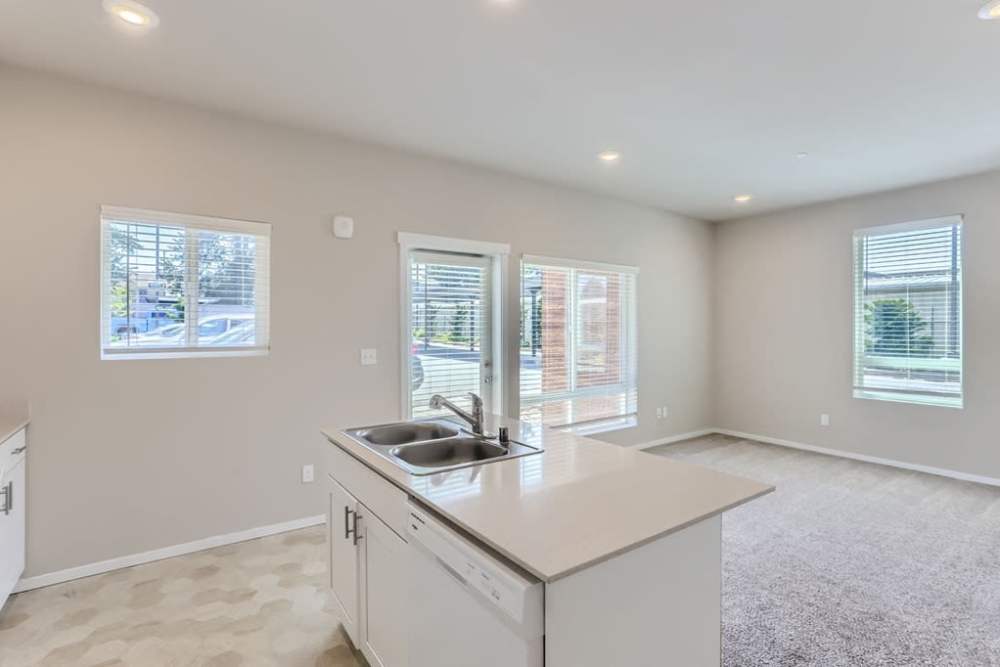 Bright living room and well-lit kitchen at The Lookout in Everett, Washington