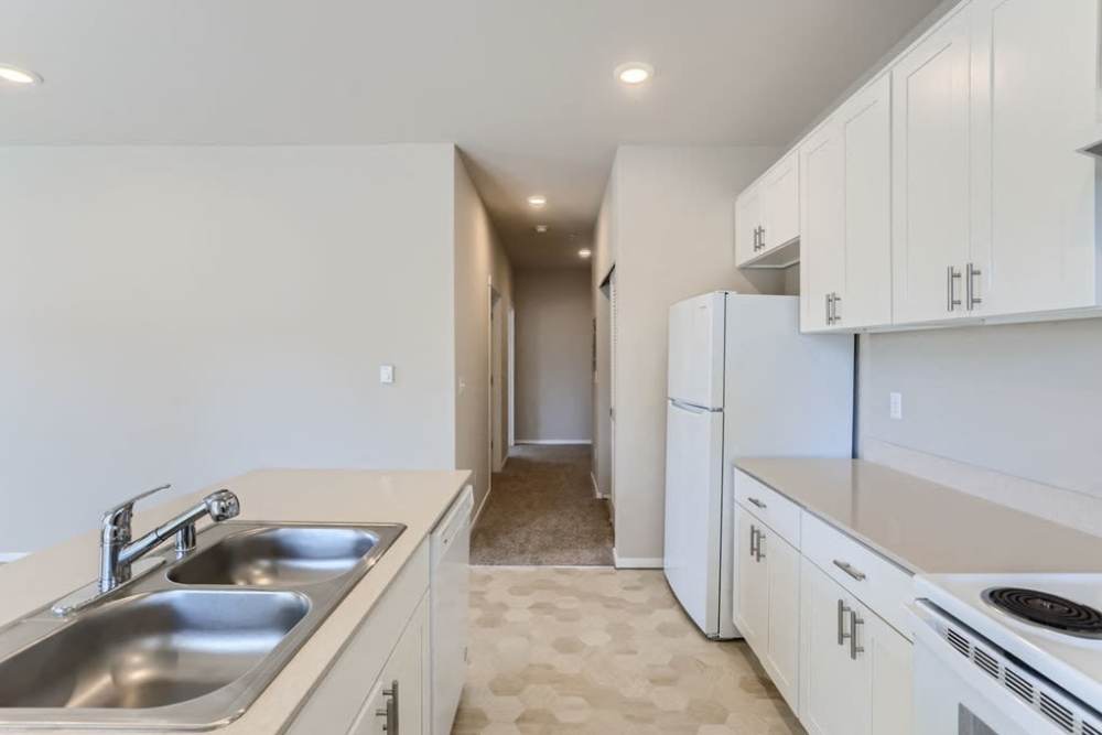 Well-lit kitchen with sink and cabinetry at The Lookout in Everett, Washington