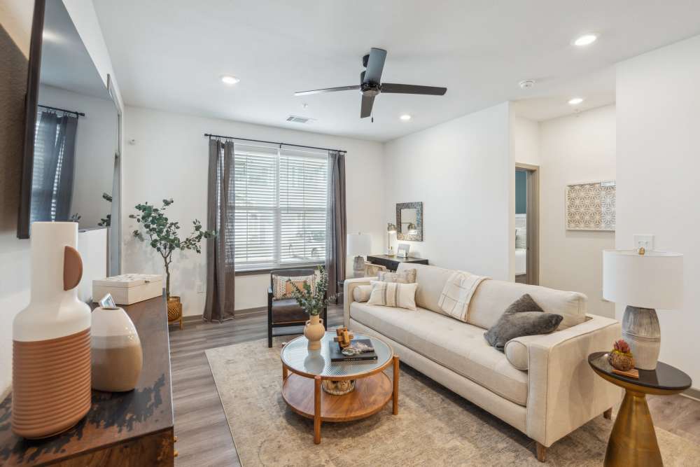 Living room with ceiling fan in a model home at Taylor Farms in Charlotte, North Carolina