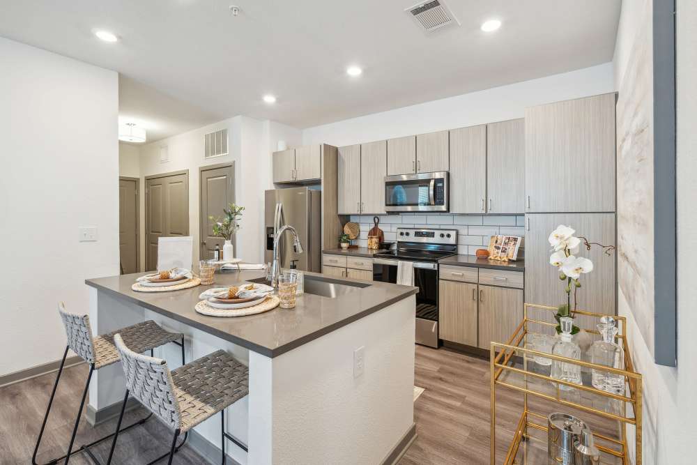 Kitchen with island and bar seating in a model home at Taylor Farms in Charlotte, North Carolina