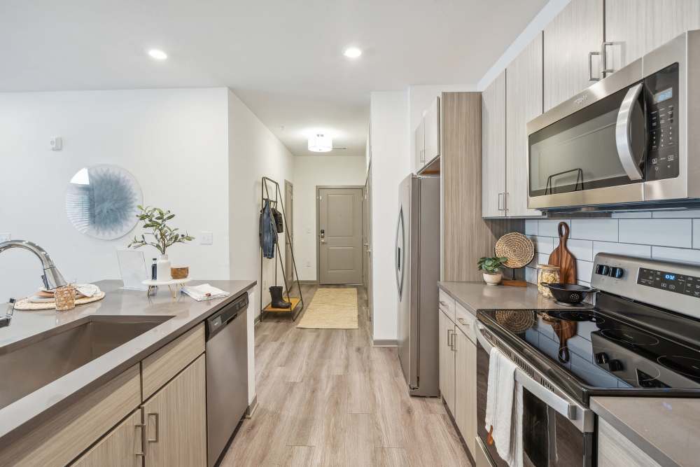 Spacious kitchen with wood floors in a model home at Taylor Farms in Charlotte, North Carolina