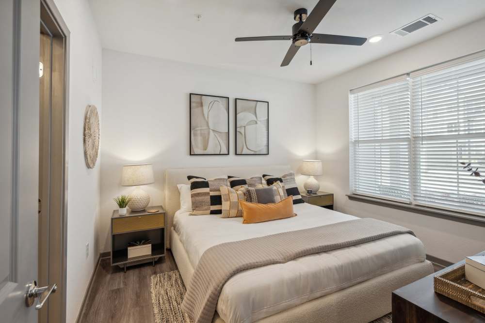 Bedroom with ceiling fan and wood flooring in a model home at Taylor Farms in Charlotte, North Carolina