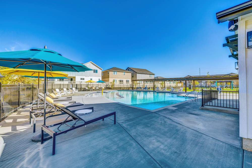 Community pool and lounging pool chairs at BB Living at The Oaks in Meridian, Idaho