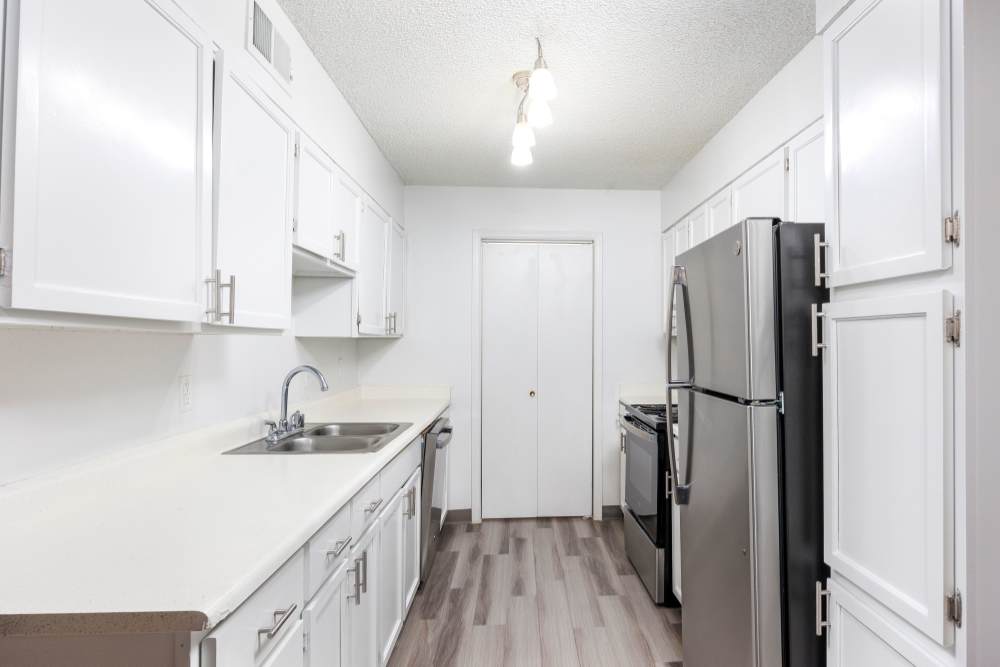 Modern kitchen featuring stainless steel appliances, granite countertops, and wooden cabinets