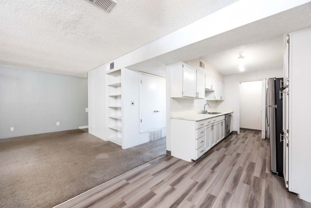 Spacious wardrobe with sliding doors, filled with neatly organized clothes.