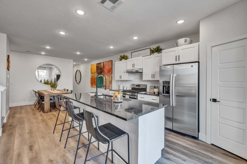 Kitchen featuring granite island and dining area at BB Living at The Oaks in Meridian, Idaho