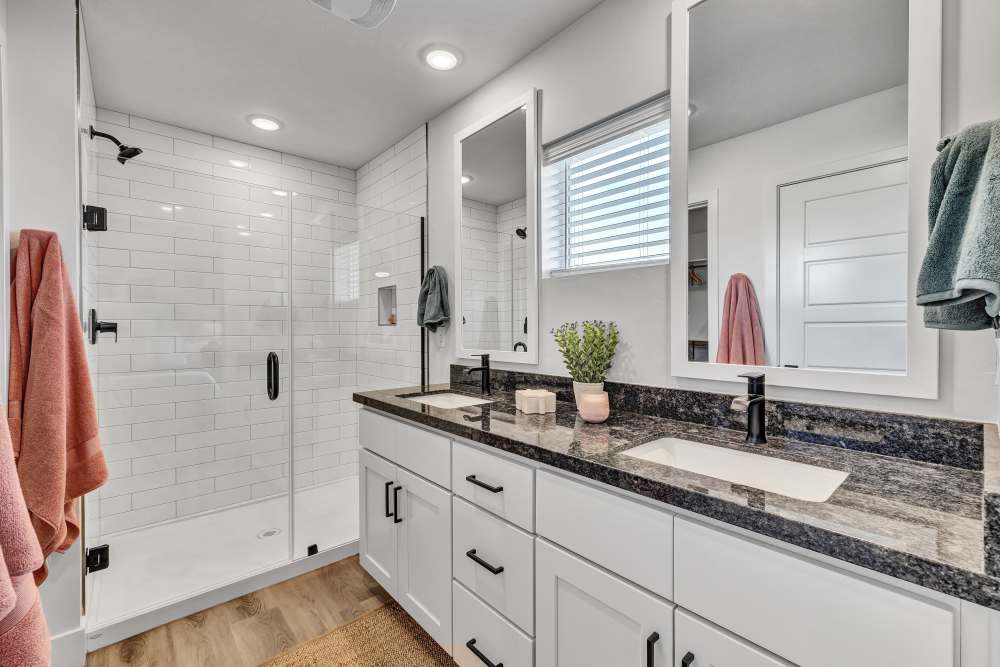 Primary bathroom featuring double vanity & walk-in shower at BB Living at The Oaks in Meridian, Idaho