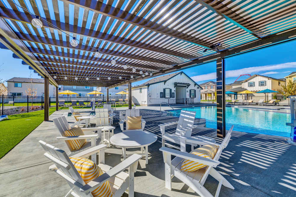 Outdoor lounge space conveniently located next to the community pool featuring shade & lighting at BB Living at The Oaks in Meridian, Idaho