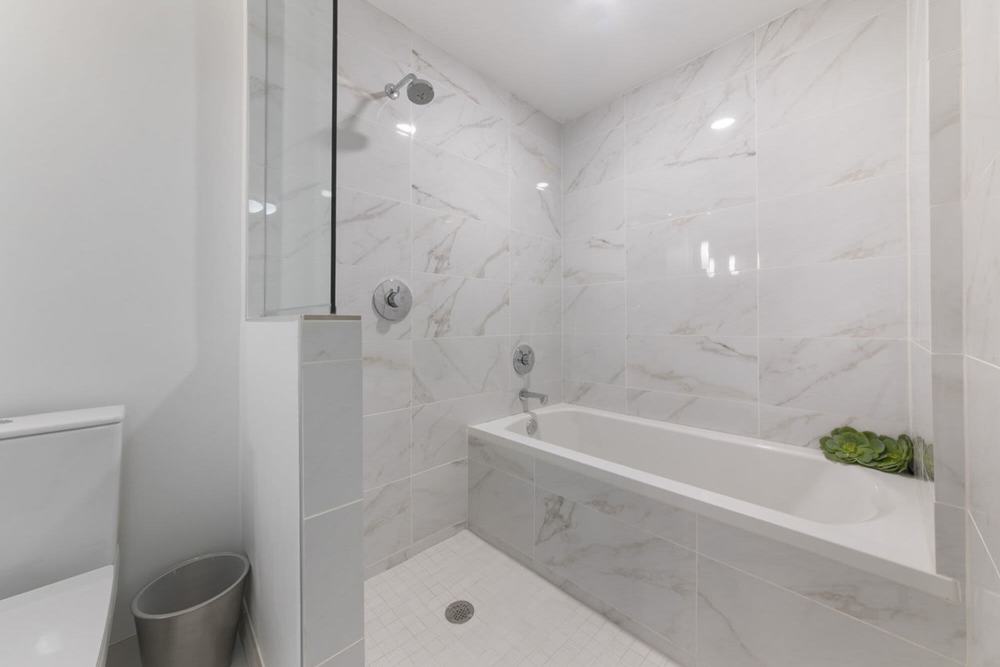 Spacious white bath tub in the bathroom at Solitair Brickell Apartments in Miami, Florida